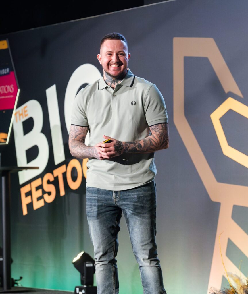 Jaxon Feeley speaking onstage at The Big Festoon